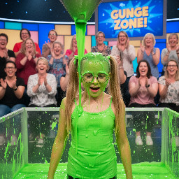 Young tween with very long blond hair in high pigtails. Wearing light green spagetti strap shirt. Has glasses. Mouth partly open.