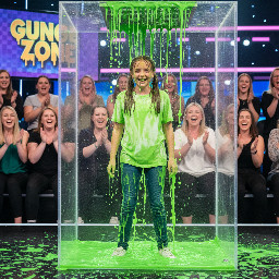 Tween girl with straight brown hair in two high pigtails (not braided). She has a timid laugh of embarressment.