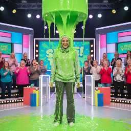 19 year old girl with light grey hijab and glasses light grey hoodie grey flair pants white sneakers