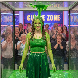 Teen girl with wavy hair in two high pigtails, wearing glasses with thin frames and a knee length skirt, with a spagetti strap top. She has shy smile, and her hands are besides her body.