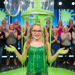 Tween with long sandy-blond wavy hair in high pigtails. Wearing tight green spagetti strap shirt. Has glasses with rectangular small frames. Playful shy smile with mouth partly open. Hands away from head. Photorealistic medium shot.